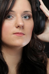 young woman listening to music on headset