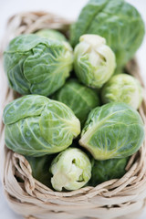 Close-up of brussels sprouts in a wicker tray, vertical shot