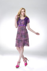 Full body attractive young girl walking in light background