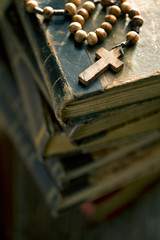 old books with rosary beads
