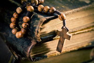 old books with rosary beads