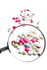 pills under magnifying glass