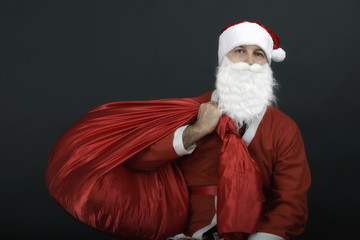 Santa Claus with christmas sack  isolated on black background