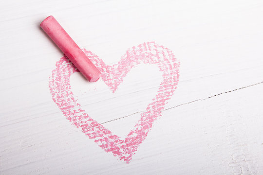 Heart Drawn With Pink Chalk On A White Wooden Background