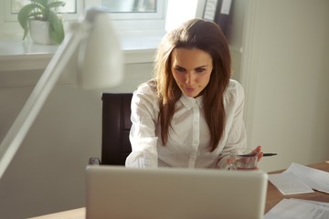 Young businesswoman working on laptop in home office
