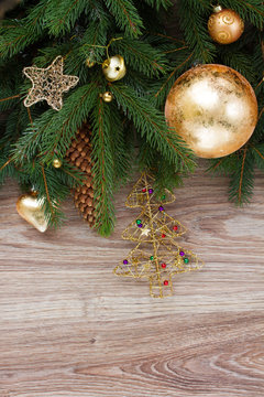golden decorations with green fir tree