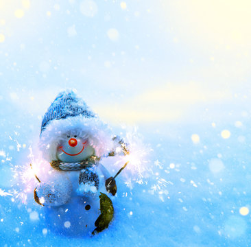 Art Christmas Snowman And Sparklers On Blue Snow Background