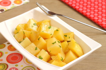 Steamed potato cubes with parsley and olive oil