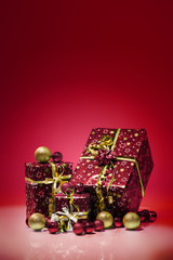 Gift boxes and christmas balls,Isolated on red background