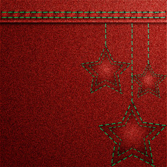 Red denim Christmas background with embroidery.