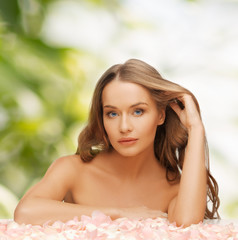 woman with rose petals and long hair