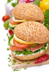burger with smoked salmon and vegetables, isolated