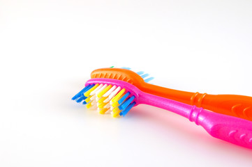 Two tooth-brushes over white
