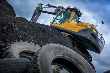 Excavator/Digger on Top of a Rubble Mountain