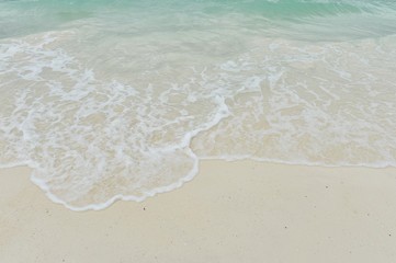 Sea wave over sand
