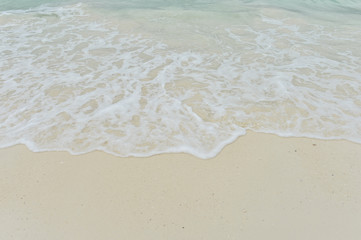 Fototapeta na wymiar Sea wave over sand