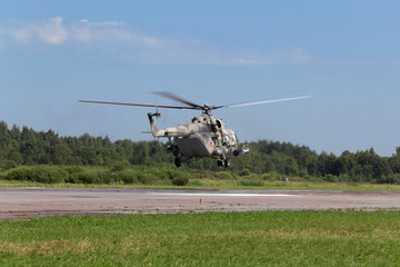 Fototapeta na wymiar The military helicopter at the airfield preparing for take-off