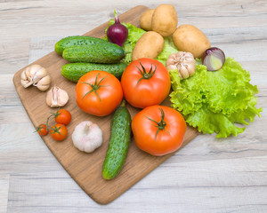 vegetables on a cutting board on a wooden table closeup
