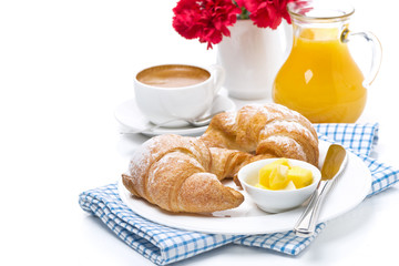 croissants with butter, cup of coffee and orange juice