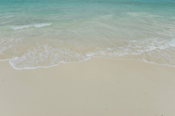 Sea wave over sand