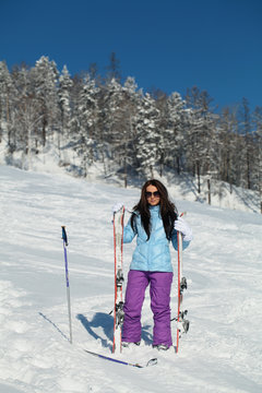 Girl with the skis at the ski slope