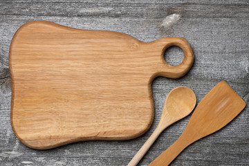 figured wooden cutting board, spoon and spatula, concept