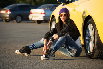 Fashionable punk woman sitting on the car parking