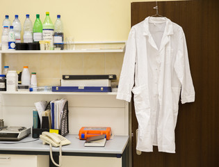 white robe of a doctor hanging in laboratory