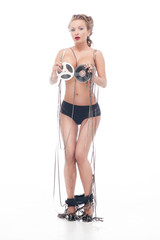 Fototapeta premium Attractive nude woman covered up with an audio retro bobbins