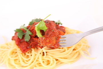 Pasta with meatballs decorated with coriander