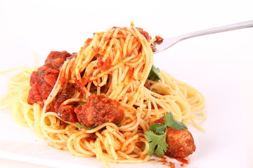 Pasta with meatballs decorated with coriander