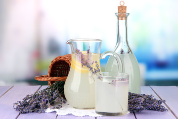 Lavender lemonade in glass bottle and jug,