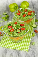 Tasty salad with fresh vegetables on wooden table