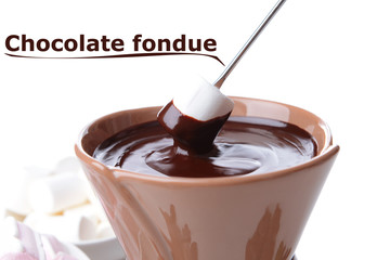 Chocolate fondue with marshmallow candies, isolated on white
