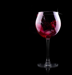 glass of red splashing wine