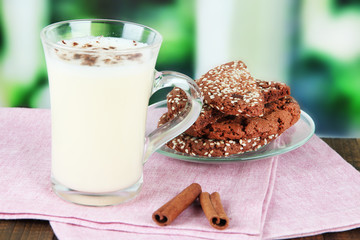 Cup of eggnog with cinnamon and cookies