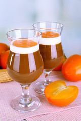 Dessert of chocolate and persimmon on table on light background