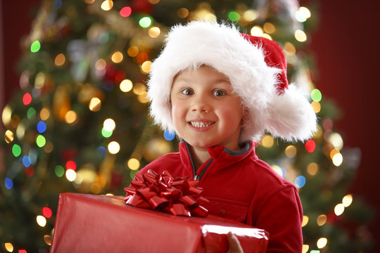 happy boy holding Christmas present