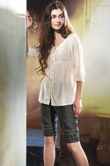 girl with long hair is in fashion style posing on wooden floor