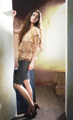 full length Slim pretty young girl posing on wooden floor