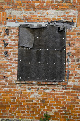 old brick wall with closed window hole