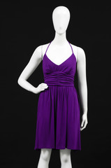 Mannequin dressed in red dress on black background