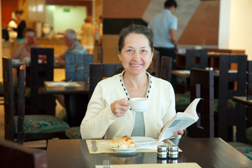 Mature woman having breakfast