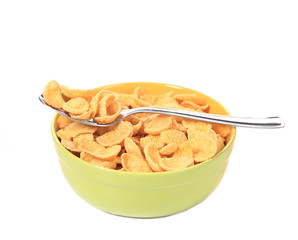 Bowl of sugar-coated corn flakes and spoon.