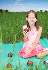 Cute little girl holding sweet red apple