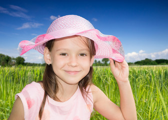 Сute little girl straightens her bonnet