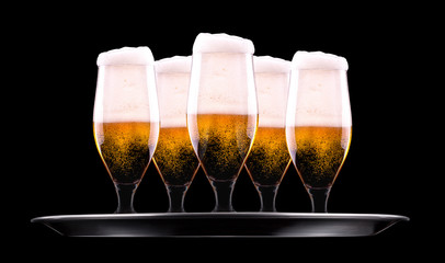 Beer into glass on a black