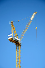 Naklejka premium Large construction crane on blue sky