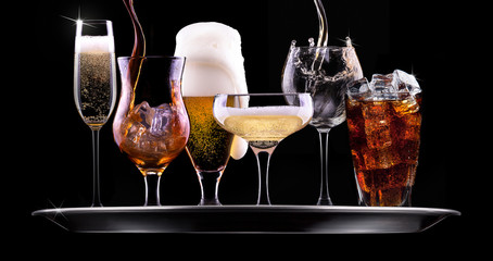 set with different drinks on black background