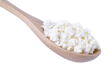 Cottage cheese in wooden spoon isolated on white